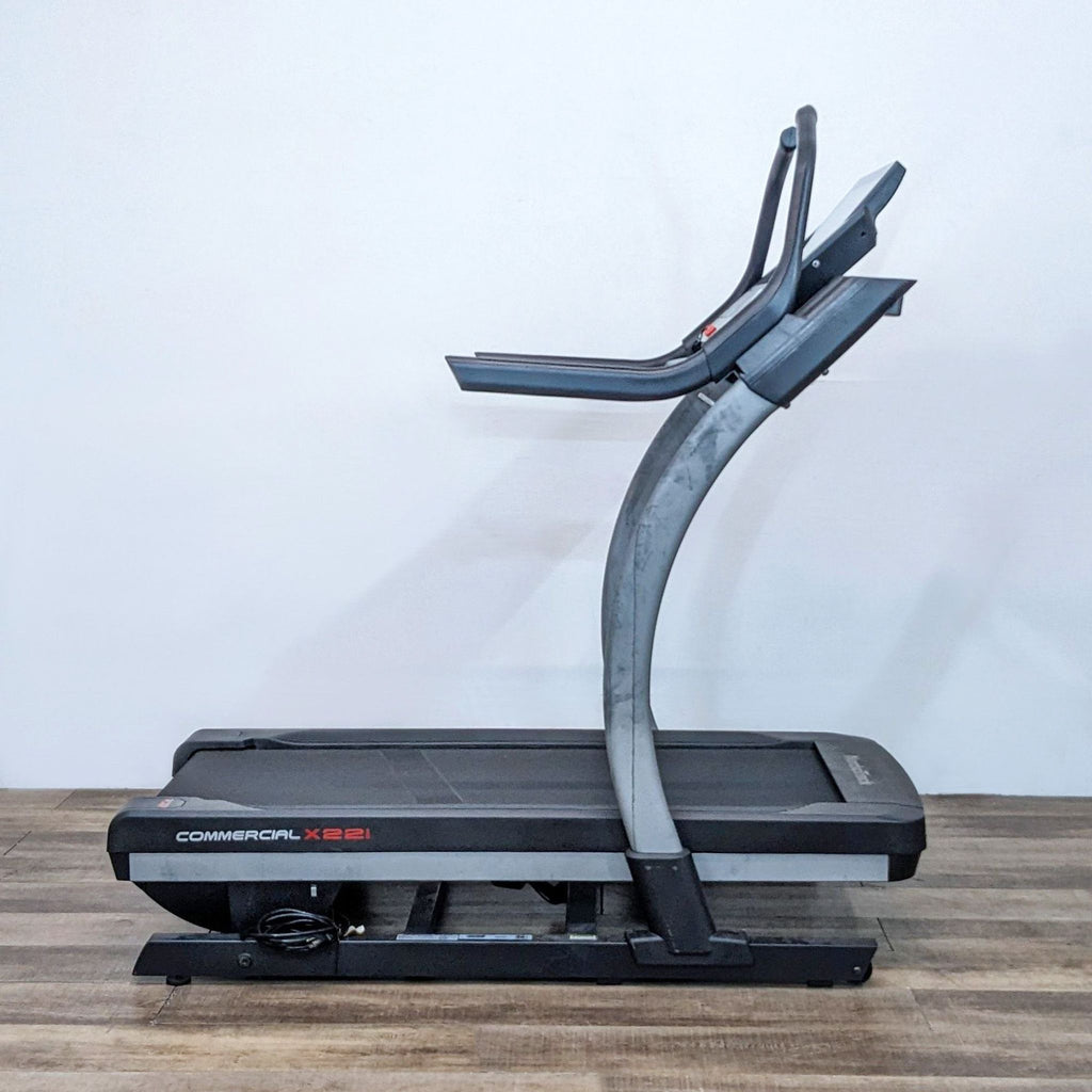 NordicTrack treadmill featuring handrails and ample running belt, in a space-saving design for cardio workouts.