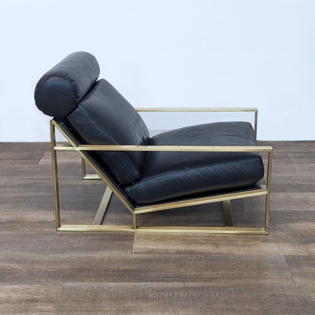 Side view of leather lounge chair with a bronze steel frame and cylindrical headrest.  