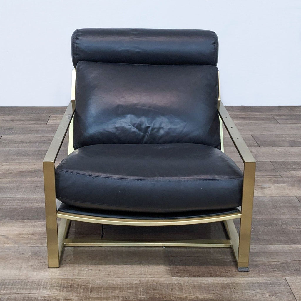 Front view of a midcentury modern lounge chair with leather upholstery and bronze frame.  