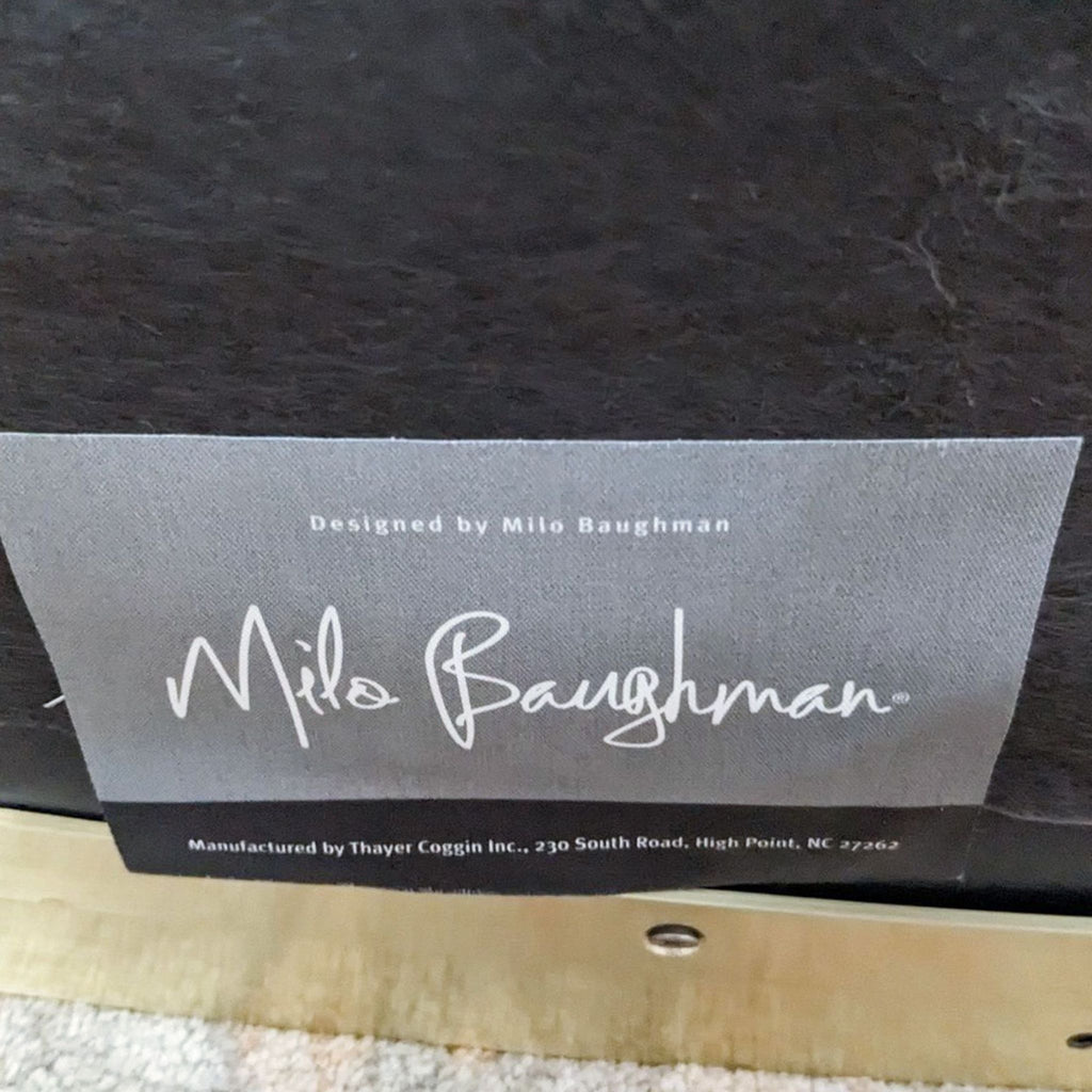 Close-up of Milo Baughman and Thayer Coggin label on a designer lounge chair.  