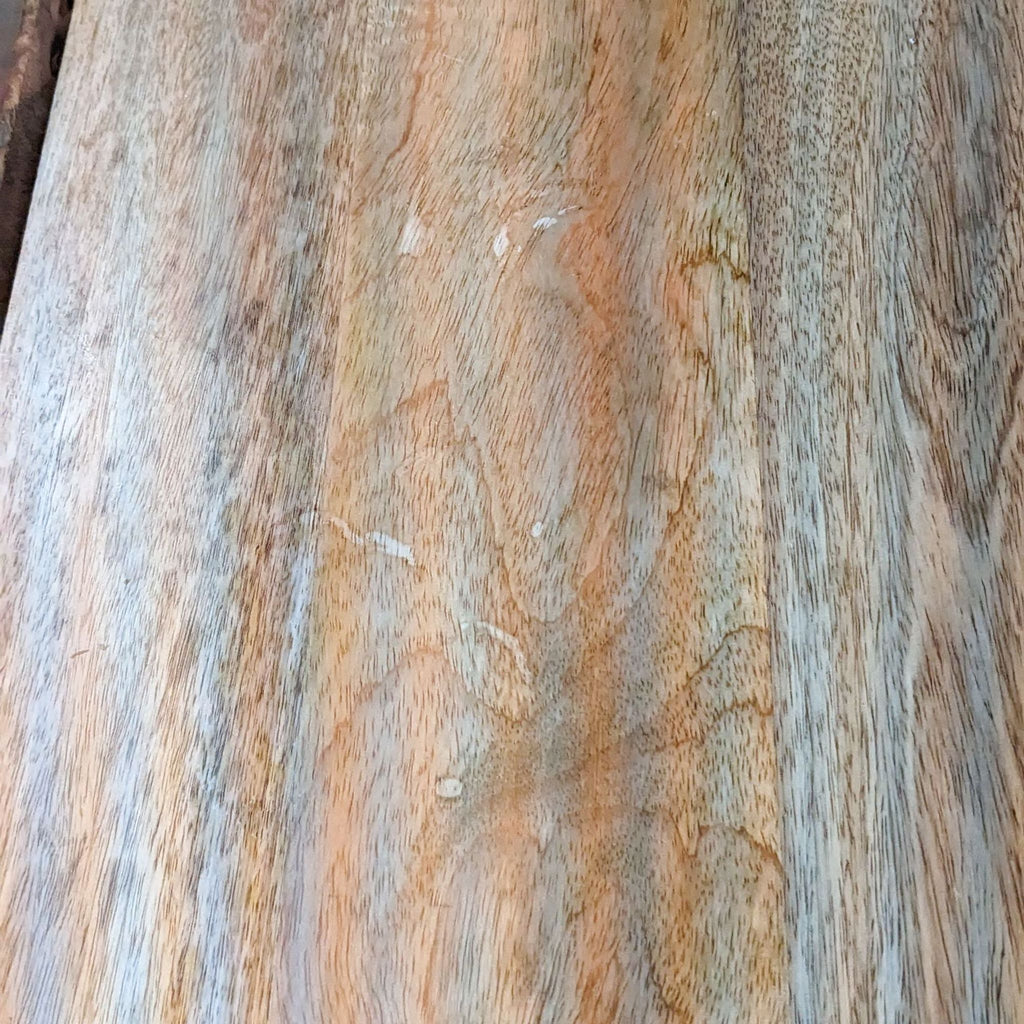 Close-up of the natural grain and texture on mango wood surface.