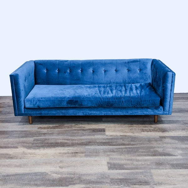 Blue velvet modern bench seat sofa with tufted back and narrow arms.