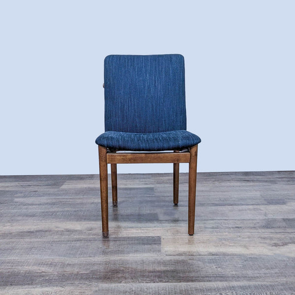 West Elm dining chair with a blue upholstered seat and double T-back detail.