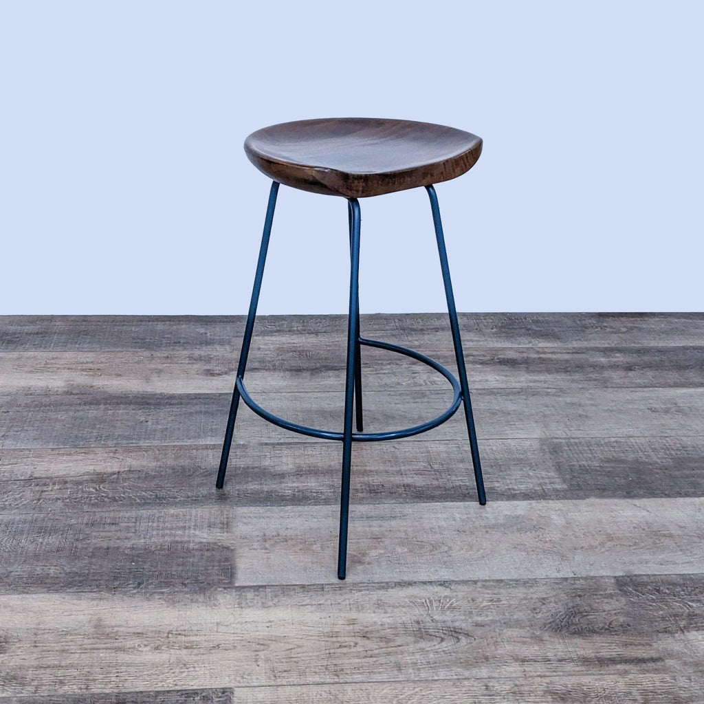 2. Side angle of West Elm Alden stool, solid wood curved seat with black steel legs, in stools and benches category.