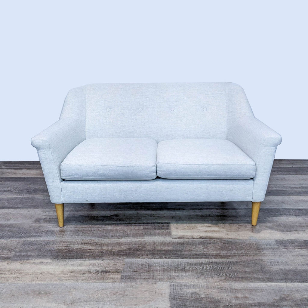 3-seat cream sofa, bench seat with slightly curved arms, light wood finish.