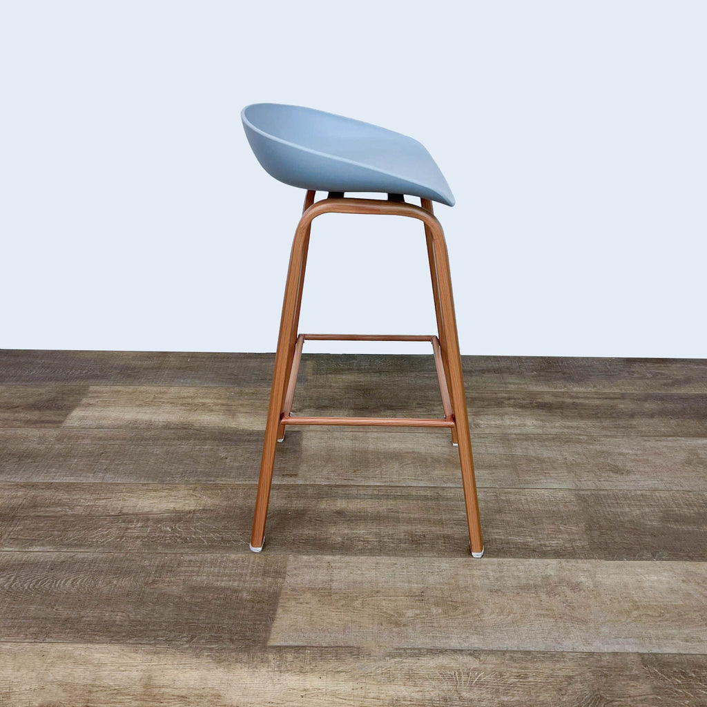 Side view of a minimalistic gray and wood barstool.  