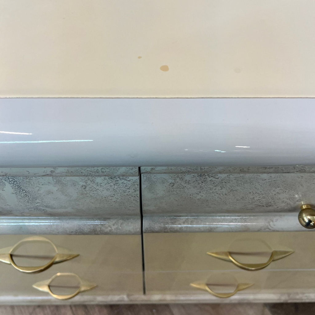 Close-up of Reperch Italian dresser drawer with gold-toned handles and faux marble accent.
