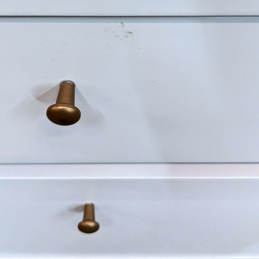 Close-up of brass knobs on Oliver Space end table drawers.