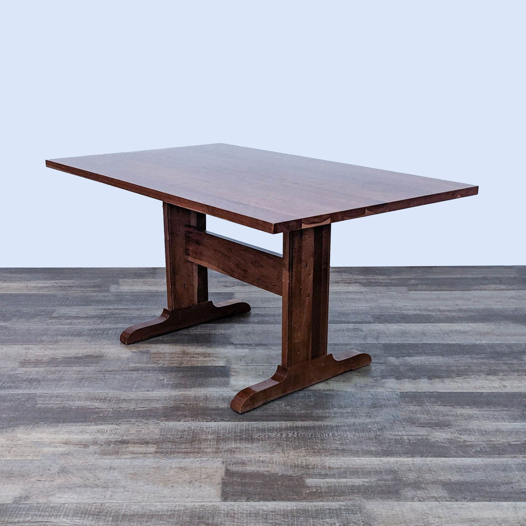 Square wooden dining table with sturdy legs by W.A. Mitchell Cabinetmakers, isolated on a grey background.