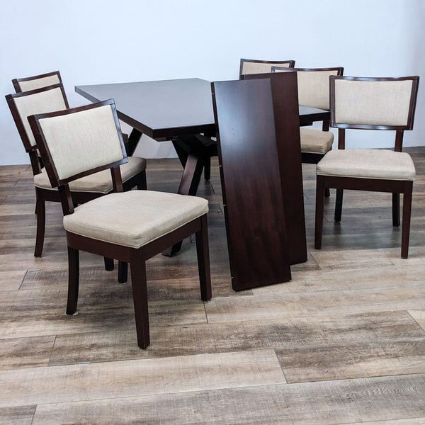 Dining set with a dark wood finish, including a table, extension leafs, and six cushioned chairs.