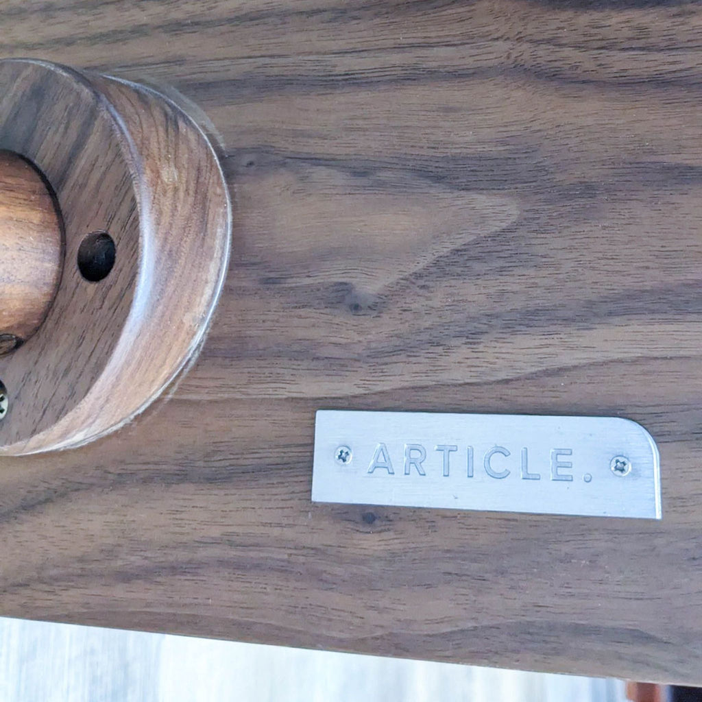 Close-up of Article brand label on wood entertainment center.