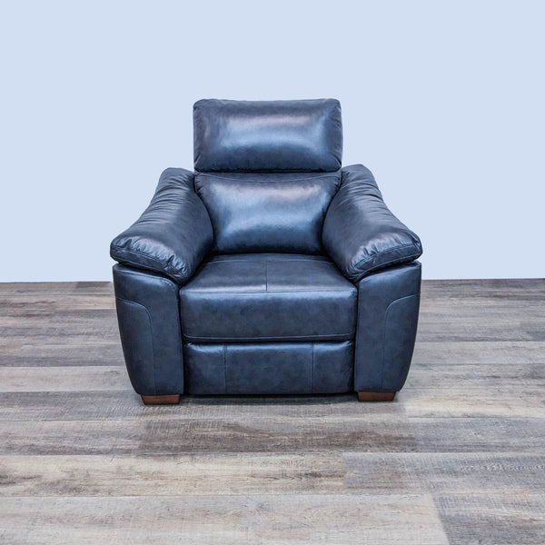 Fremont & Park Larue power recliner in upright position, black leather, with wood legs on a wooden floor.
