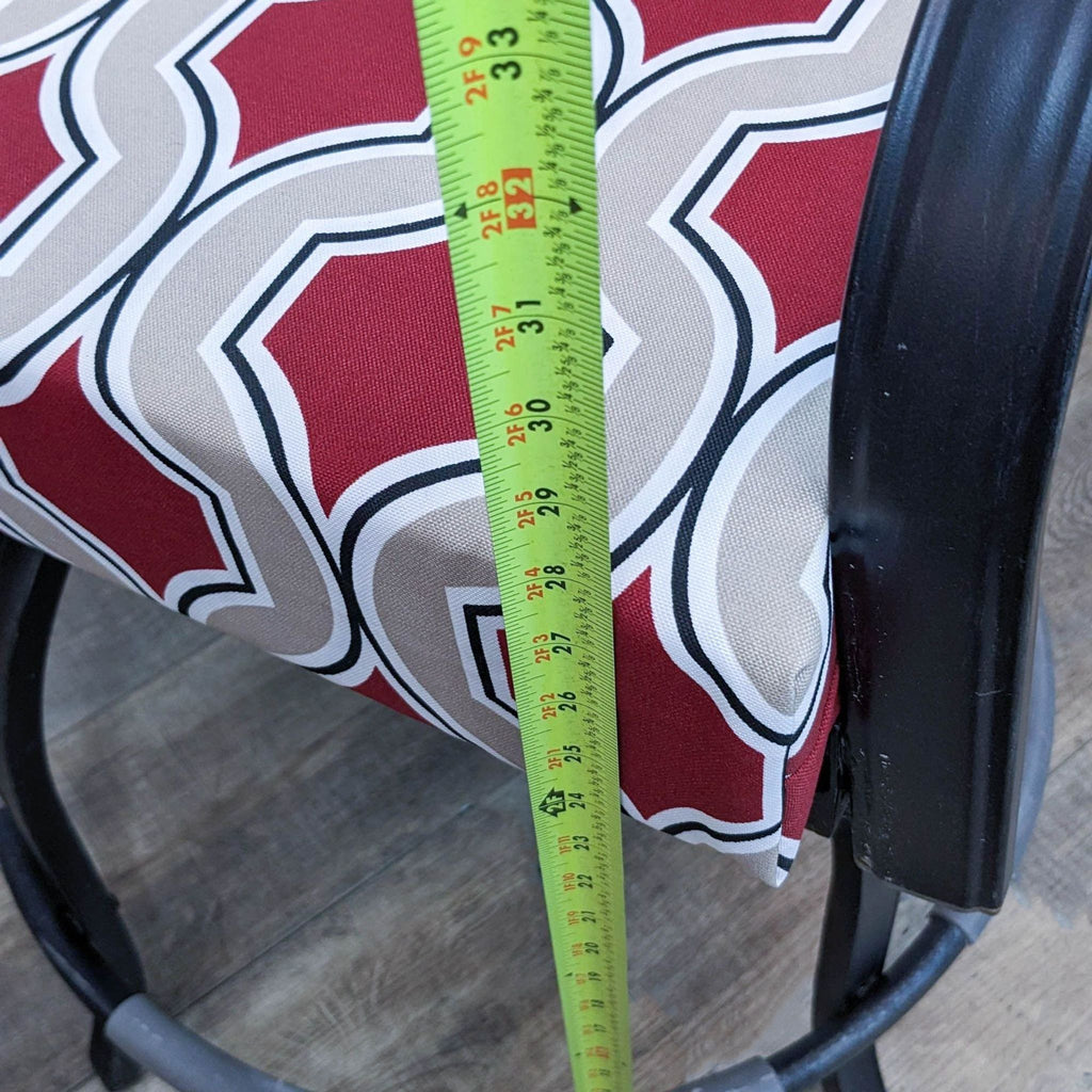 Close-up of cushion with red and white geometric pattern.  