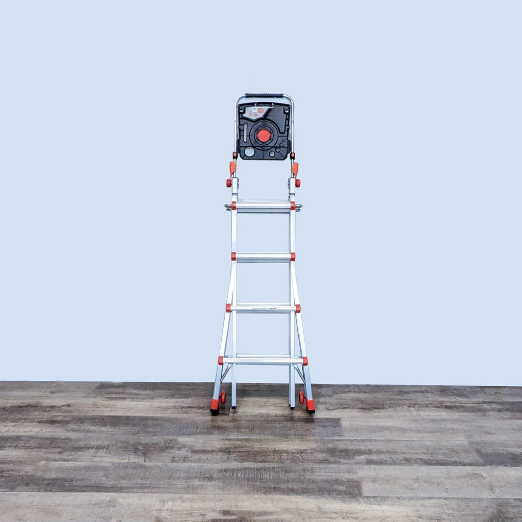 A Little Giant aluminum ladder in an extended position with slip-resistant rungs and non-marring red feet, against a gray backdrop.