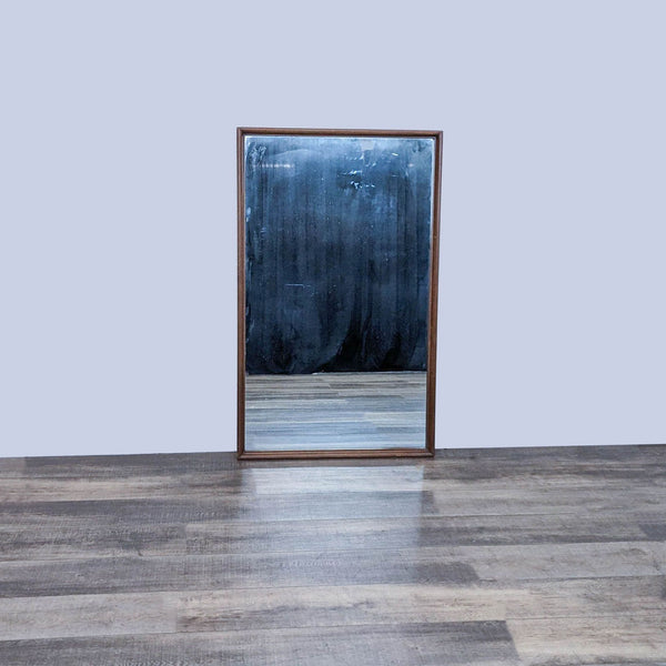 Vintage wall mirror with oak frame by Reperch, reflecting wooden flooring.