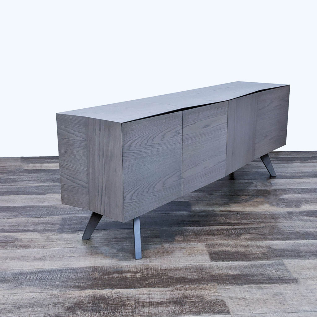 Roche Bobois' sideboard designed by Christophe Delcourt with offset lines and oak veneer, accented by silver patina handles.