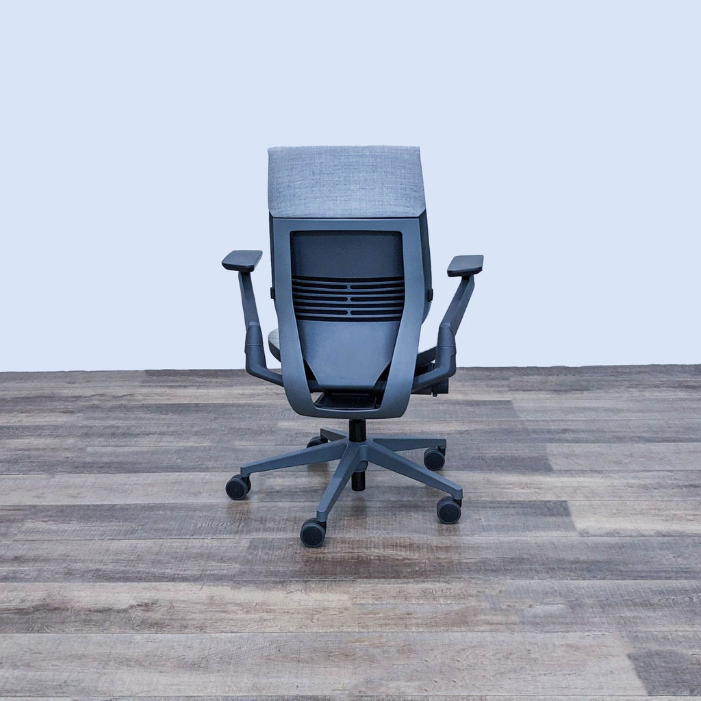 Back view of Steelcase Gesture chair showing shell back design and adjustable arms.