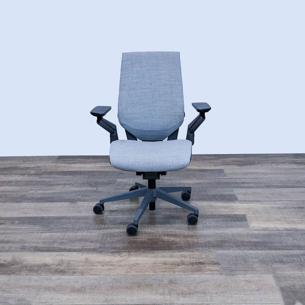 Front view of Steelcase Gesture office chair with adjustable features on wooden floor.