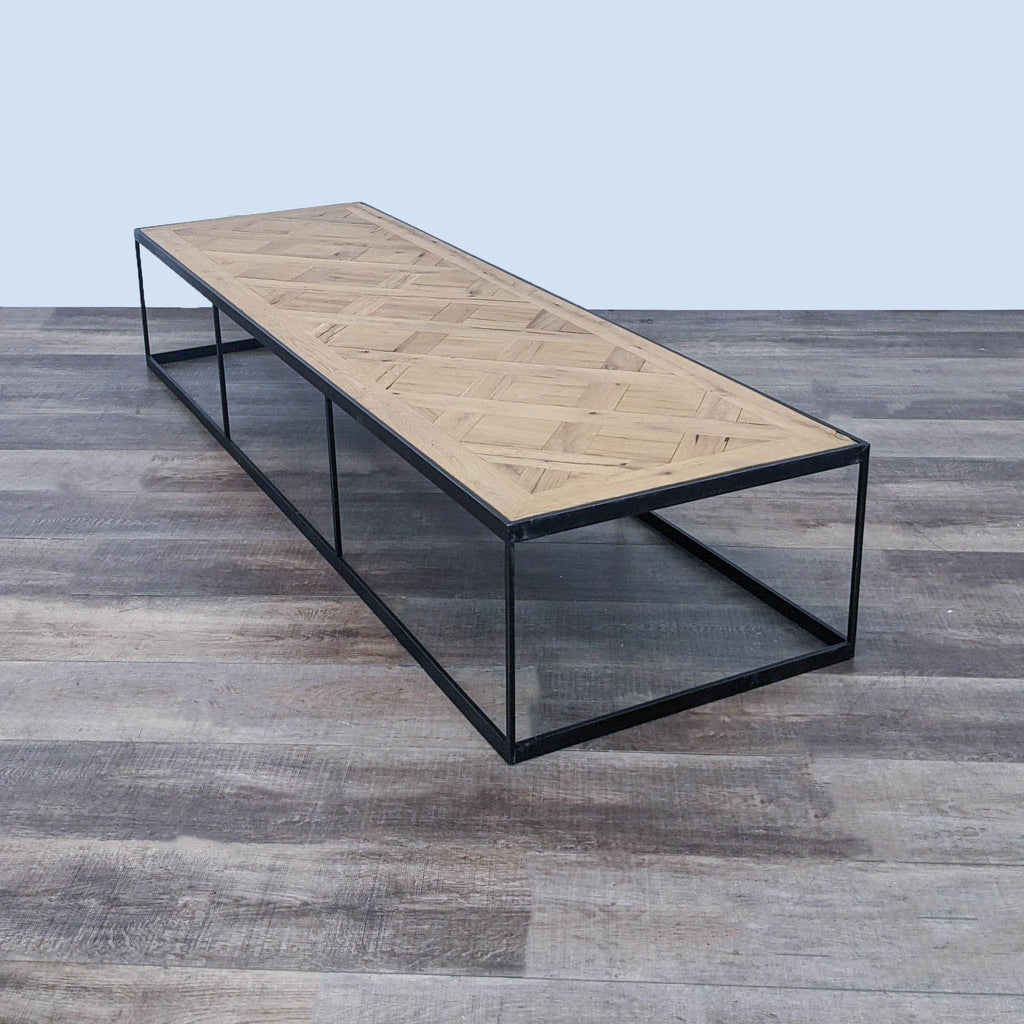 Reperch brand coffee table with a metal box frame and herringbone wood top on a wooden floor.