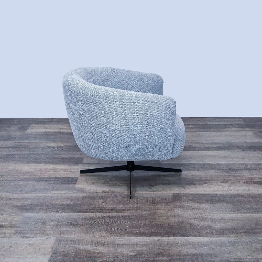 Side view of a textured light grey lounge chair with smooth 360-degree swivel capability.