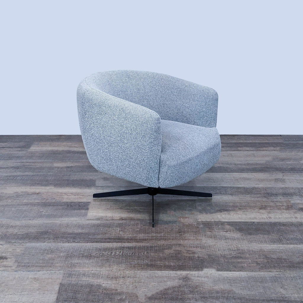 Angled view of a modern swivel chair with light grey chenille fabric and black metal base.