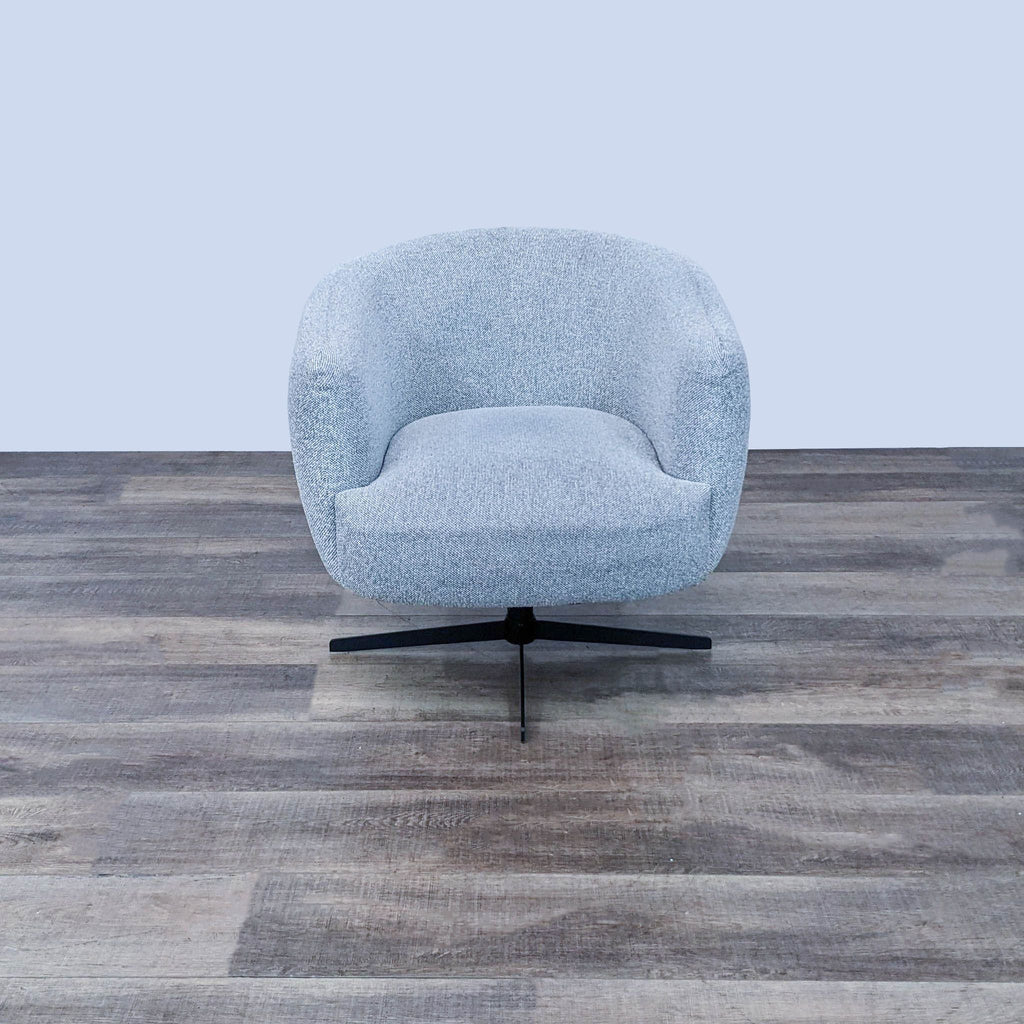 Front view of a light grey swivel lounge chair with a metal base on wooden floor.