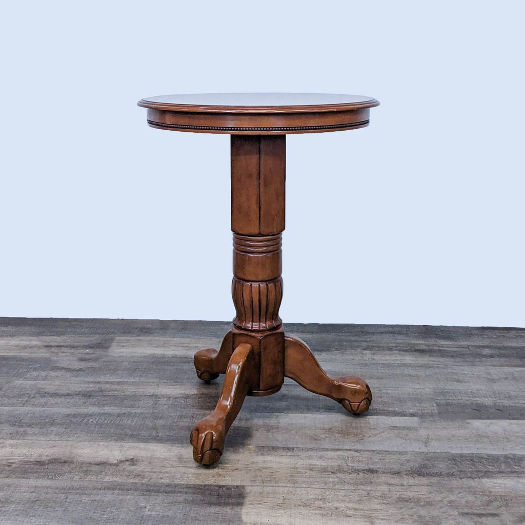 Round wood pedestal table with intricate design from Pier 1 Imports.