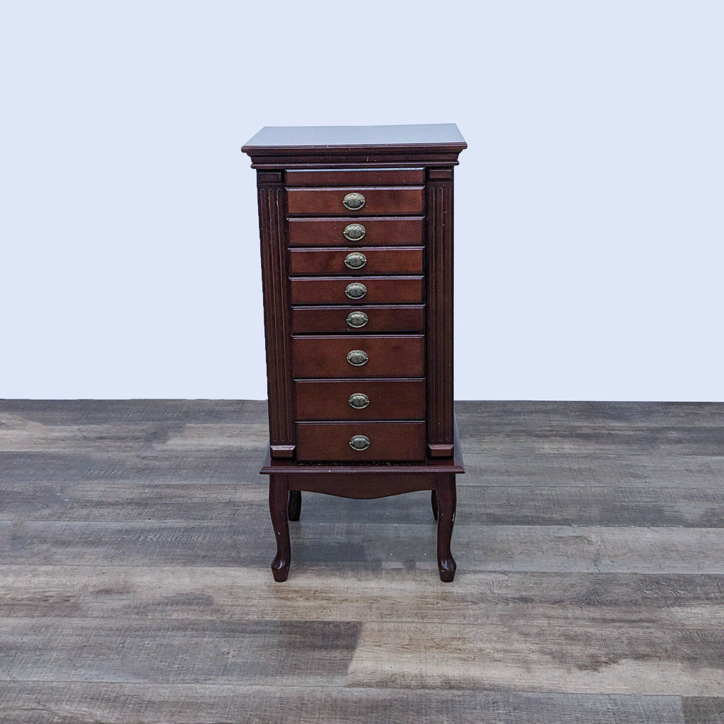 Elegant wooden jewelry armoire with eight drawers and dark finish.