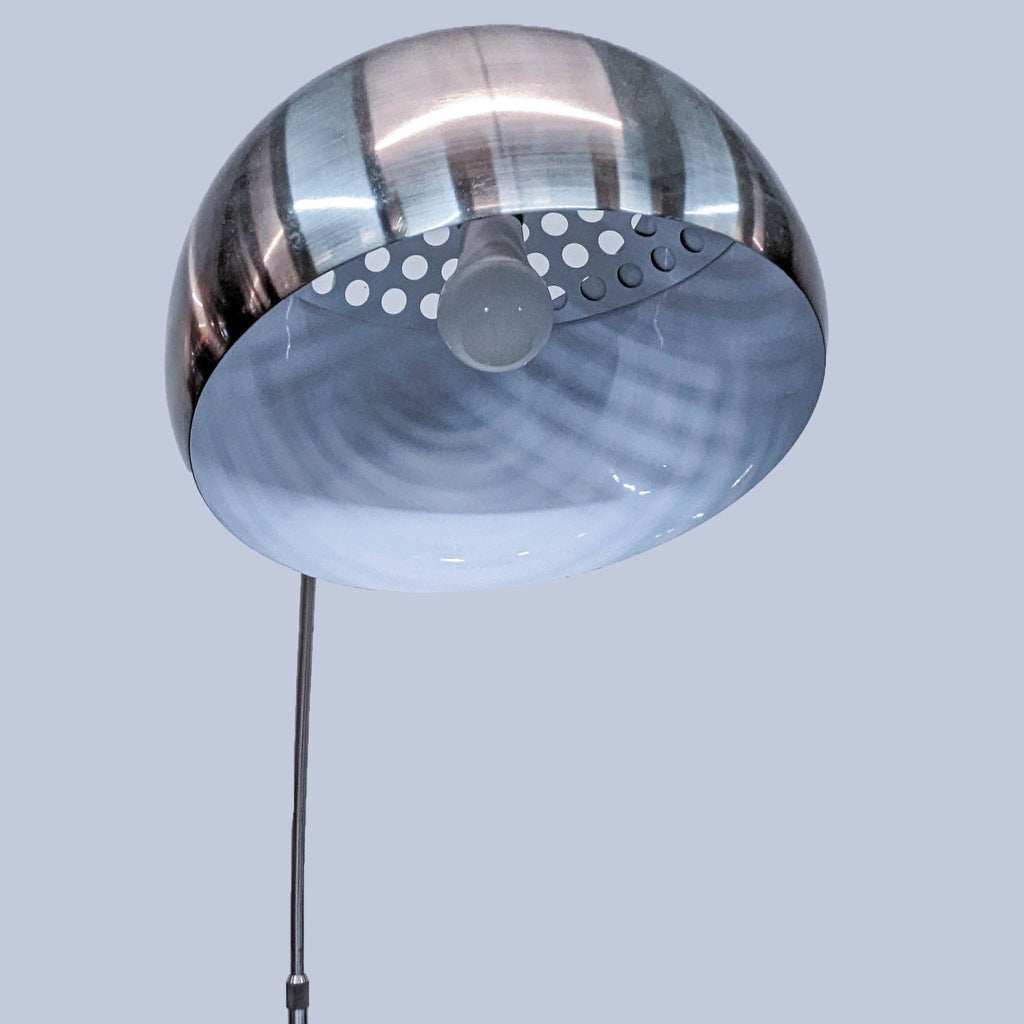 Close-up of the Reperch lamp's metallic dome shade and bulb, part of the Lighting collection.