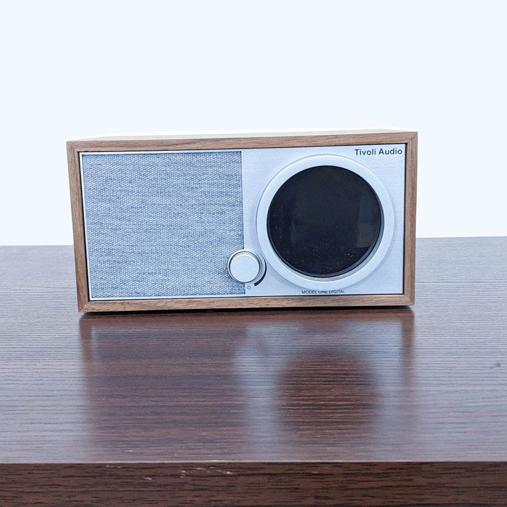 Compact Tivoli Audio speaker with walnut-finish, fabric grill, and Wi-Fi capabilities for modern streaming.