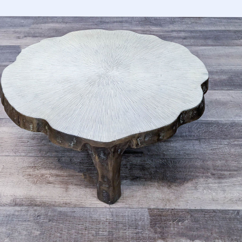Unique aluminum coffee table with textured top, inspired by the natural form of a lily pad.