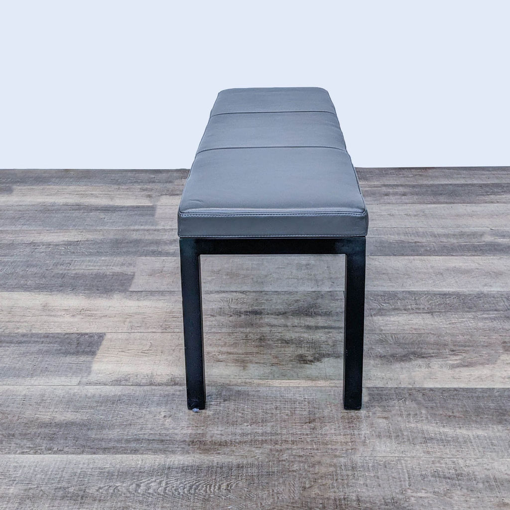 Stylish wood frame bench featuring a padded seat, adds comfort and elegance to various spaces.