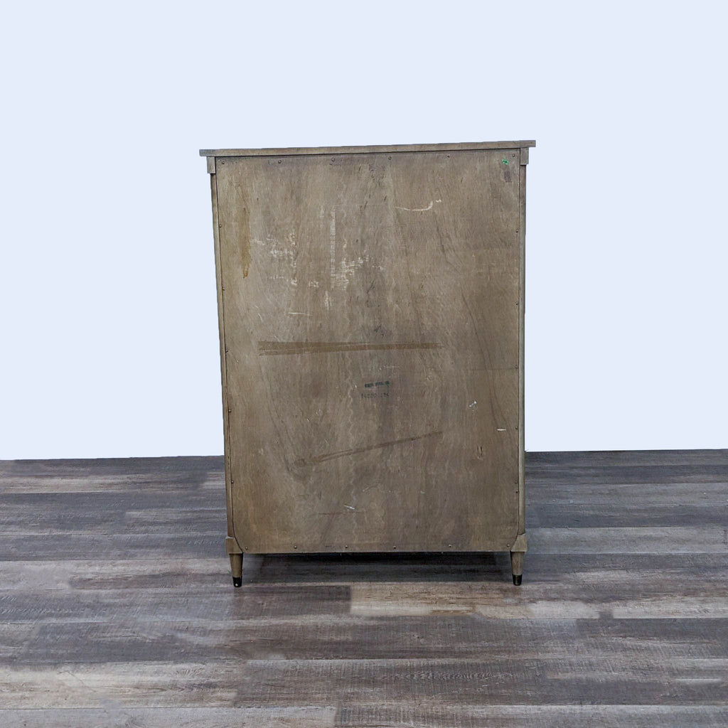 3. Back view of the Reperch wooden chest of drawers with a rustic, unfinished appearance.