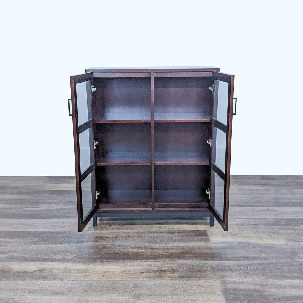 Wooden Crate & Barrel cabinet, open glass doors revealing interior shelving.
