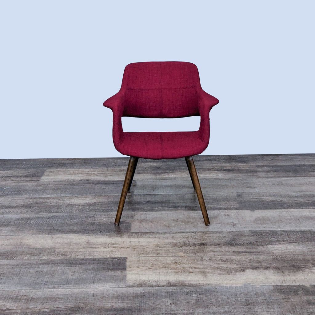 Front view of a red dining chair with wooden legs by LumiSource.