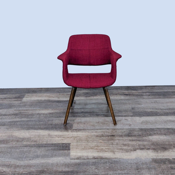 Front view of a red dining chair with wooden legs by LumiSource.