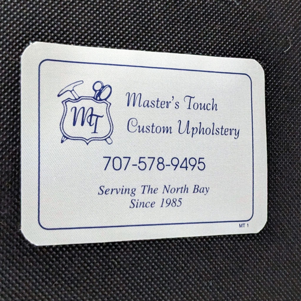 Business card for Master's Touch Custom Upholstery with contact information, on a textured background.