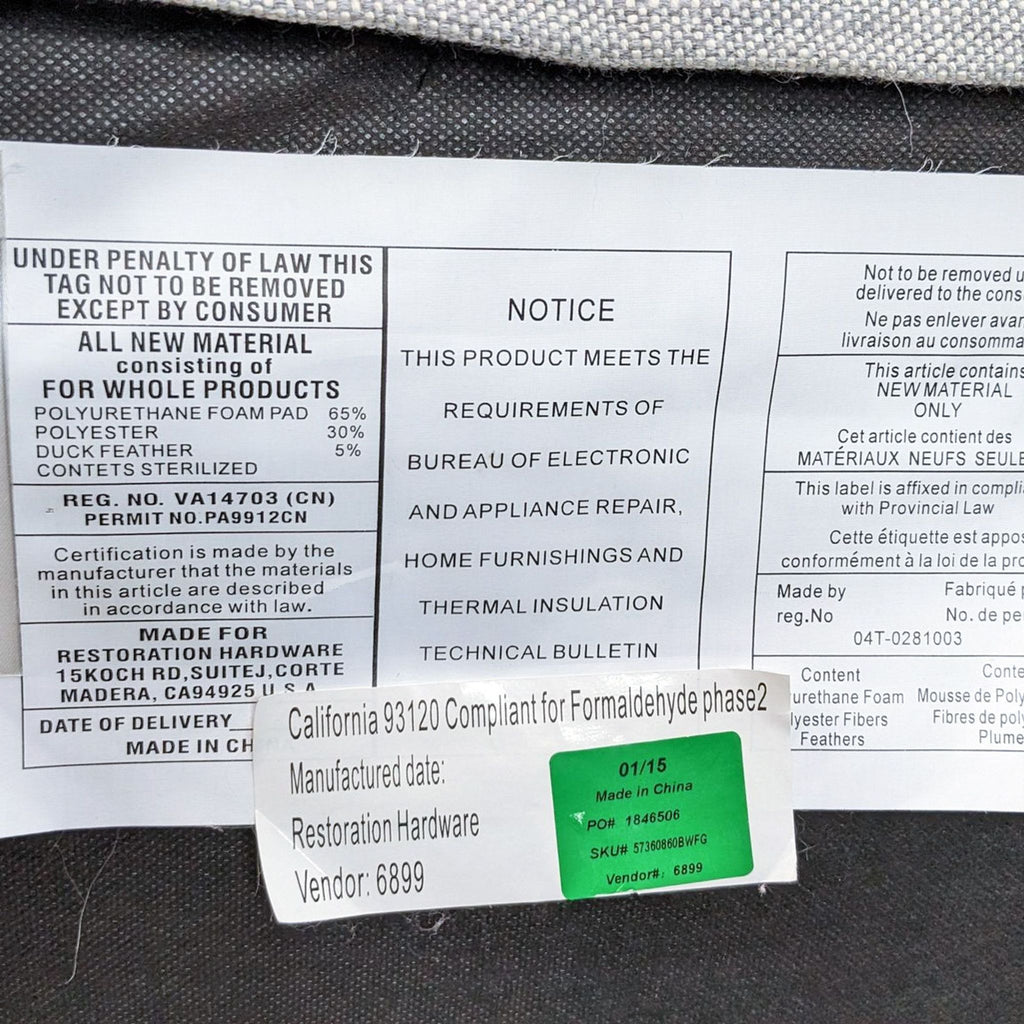 Law tag and green production label on a Restoration Hardware Belgian Slope Arm Slipcover Sofa, showing material composition and compliance information.