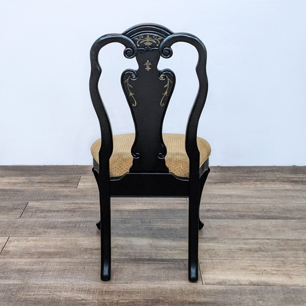 Alt text: A.R.T. Furniture Co. Queen Anne style black dining chair with floral detailing and a cushioned seat.