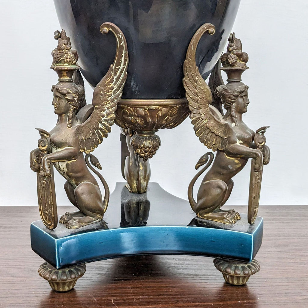 a large antique bronze and marble urn with two cherubs