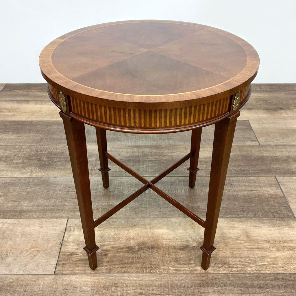 Elegant wooden Century end table featuring metal inlay and crossed legs, displayed on a hardwood floor.