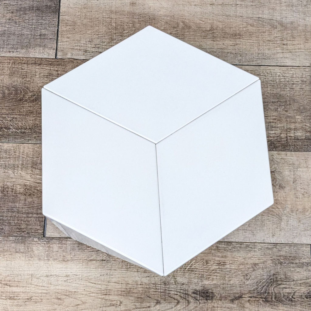 White hexagonal side table with a minimalist design, made from aluminum.