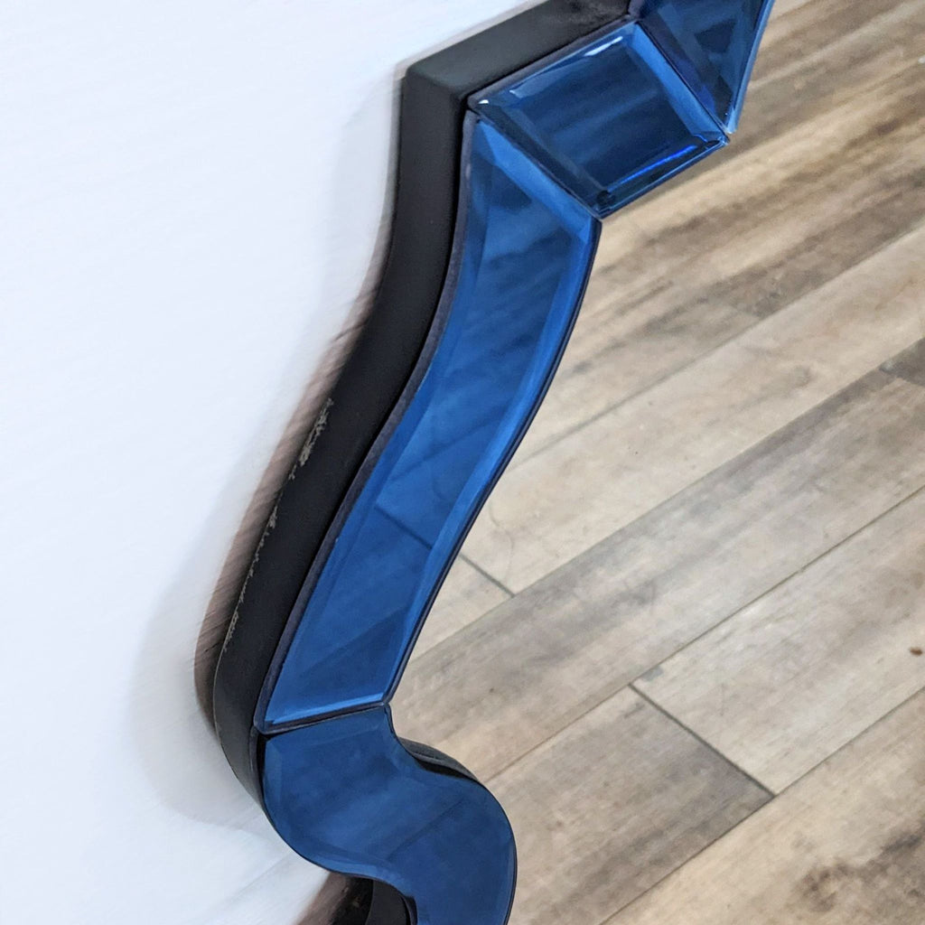 Detailed view of the beveled blue border on a Mirror Image Home mirror.