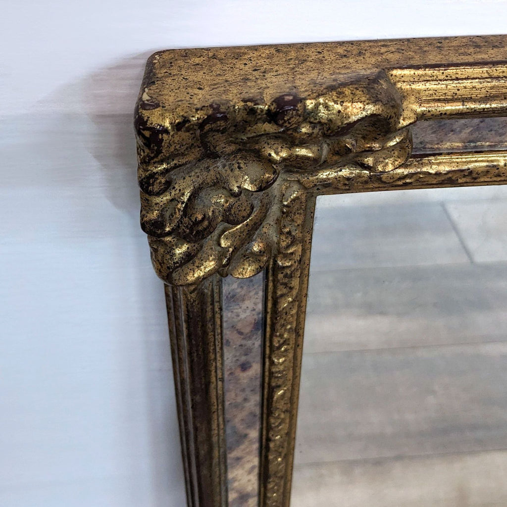Close-up of the Reperch mirror's intricate gold ornate corner detail, highlighting its vintage design and texture.