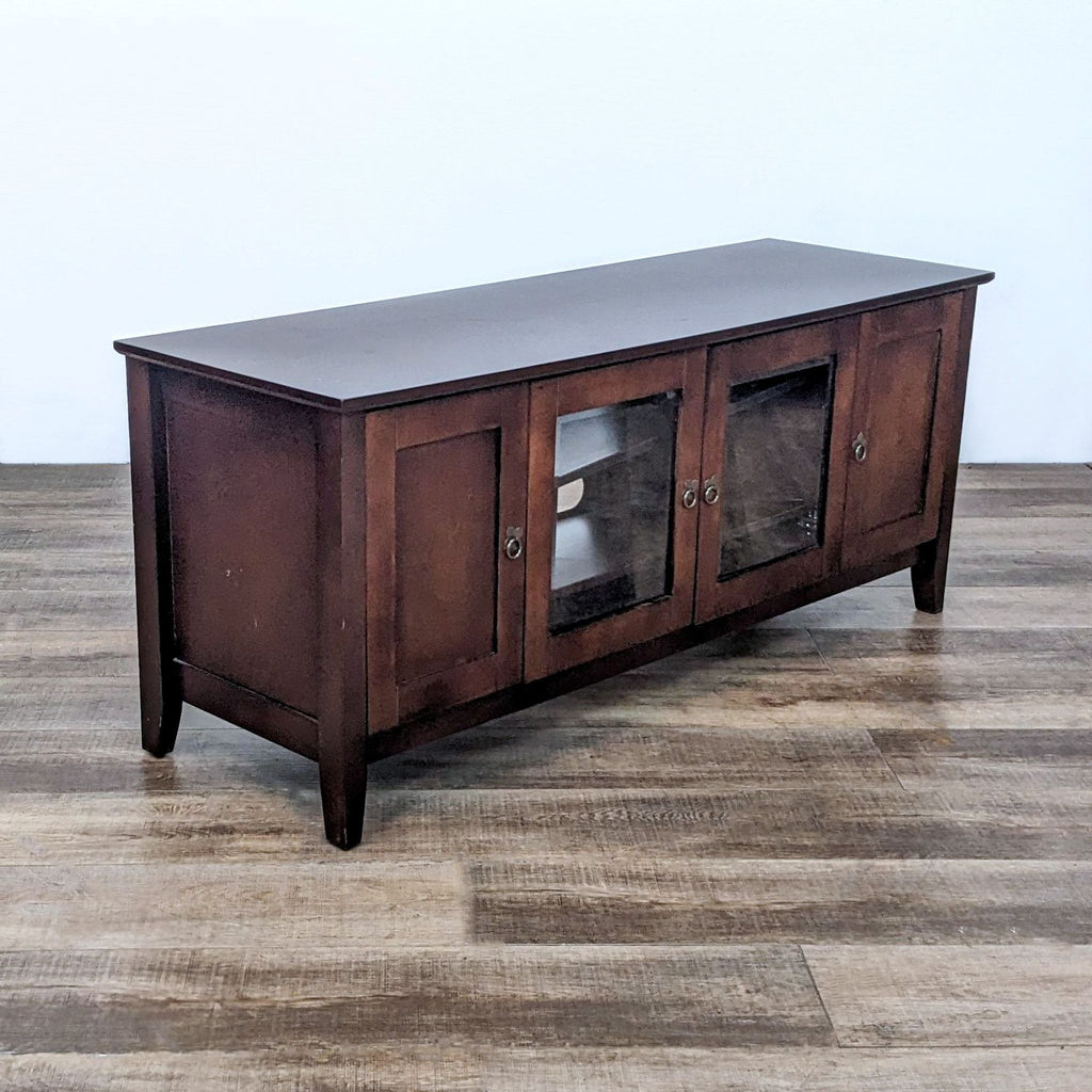 Wooden Reperch Entertainment Center, featuring side storage and central glass-protected shelves, on a parquet floor.