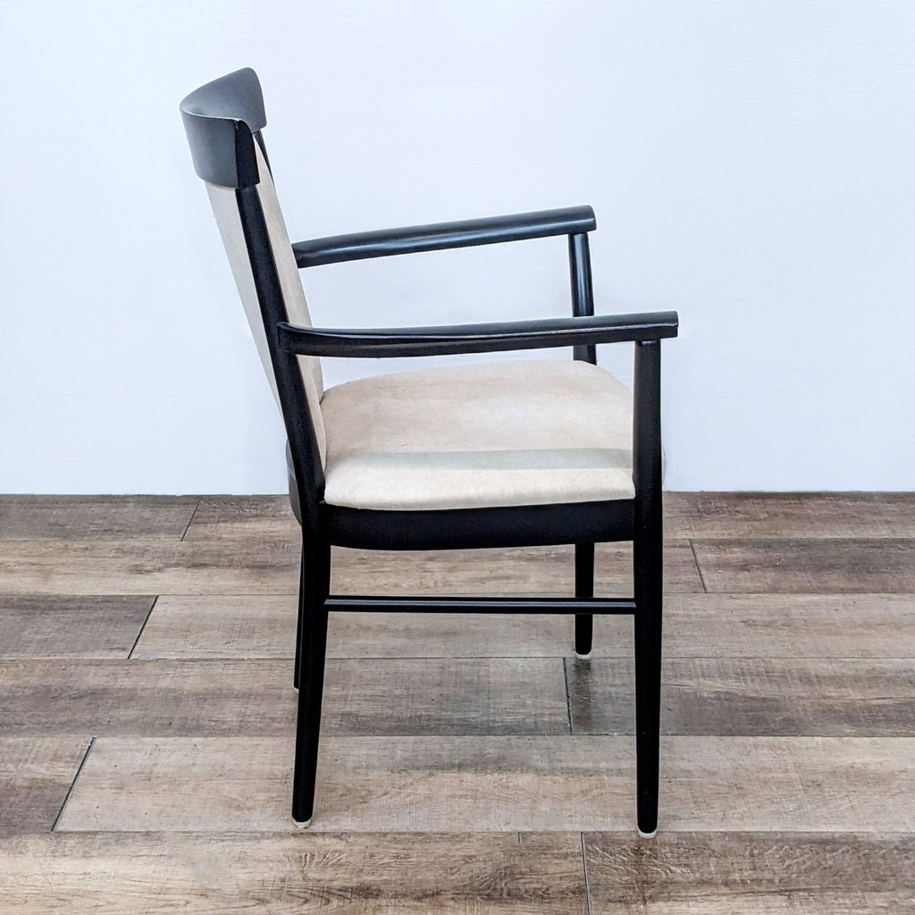 Reperch contemporary armchair with black frame and beige upholstery.