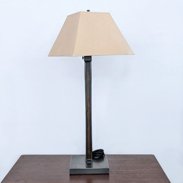 Reperch lamp with a square shade on a table, minimalist design.