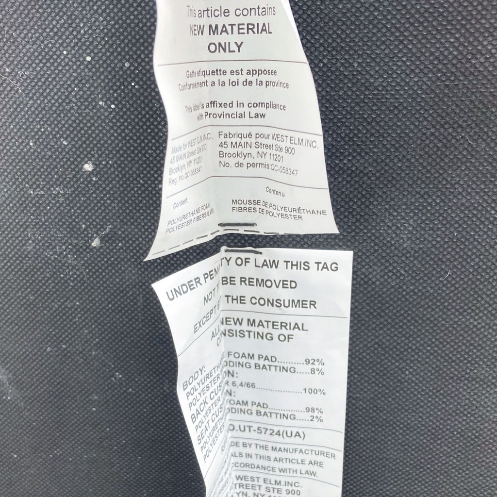 Labels on a gray fabric surface, indicating material content.