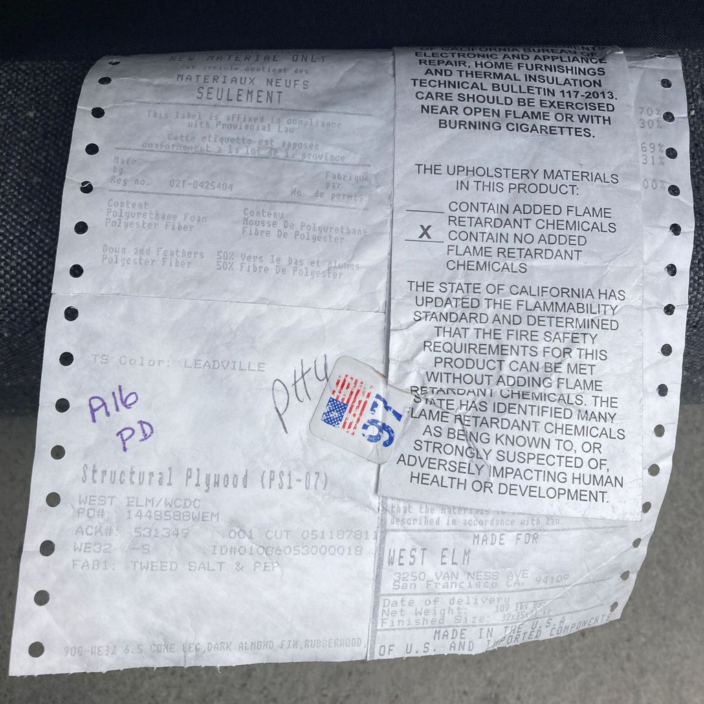 Close-up of a label detailing materials and safety info for a West Elm sofa.