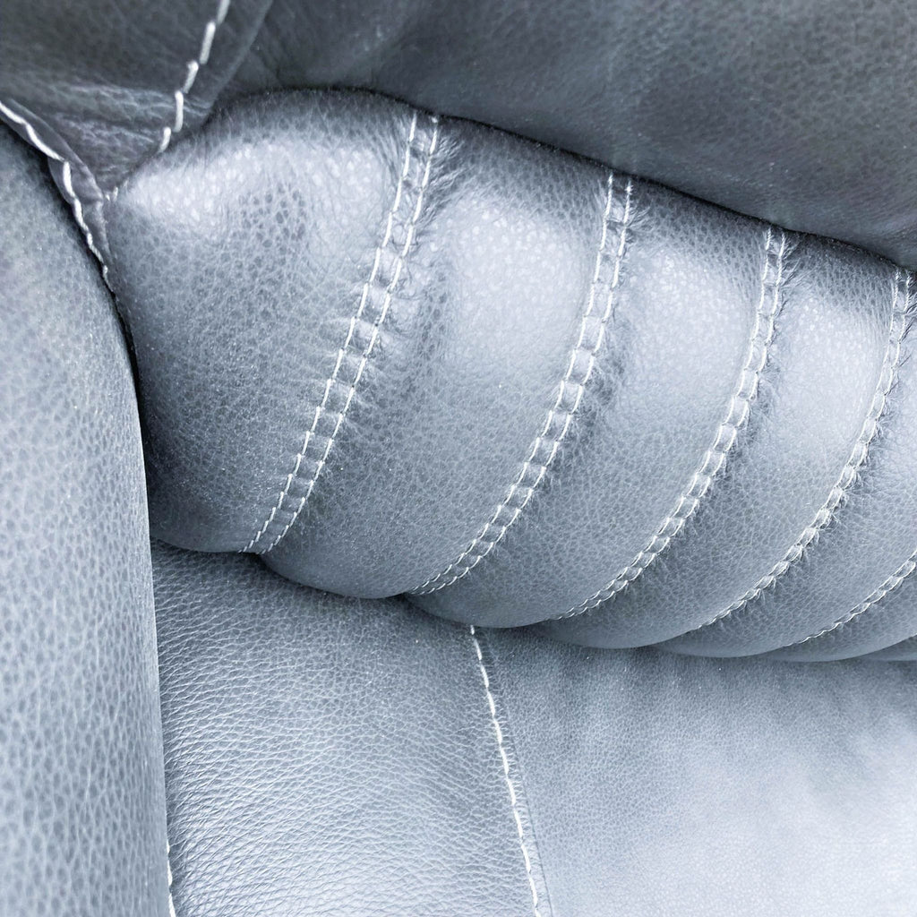 3. Detailed view of the top stitching and cushioning on a Reperch sofa's lumbar support area, highlighting the high-quality craftsmanship.